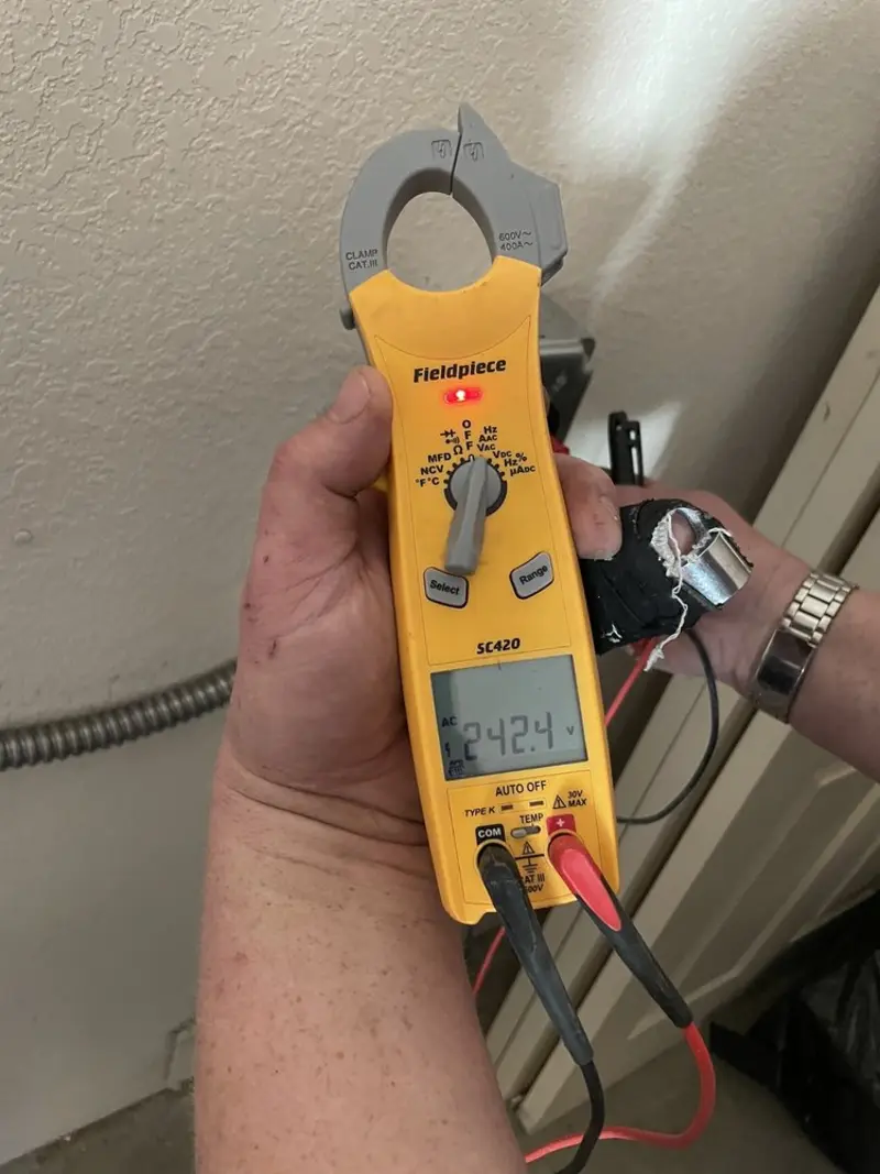 Voltage testing with clamp meter during Recessed Lighting Installation in Senatobia